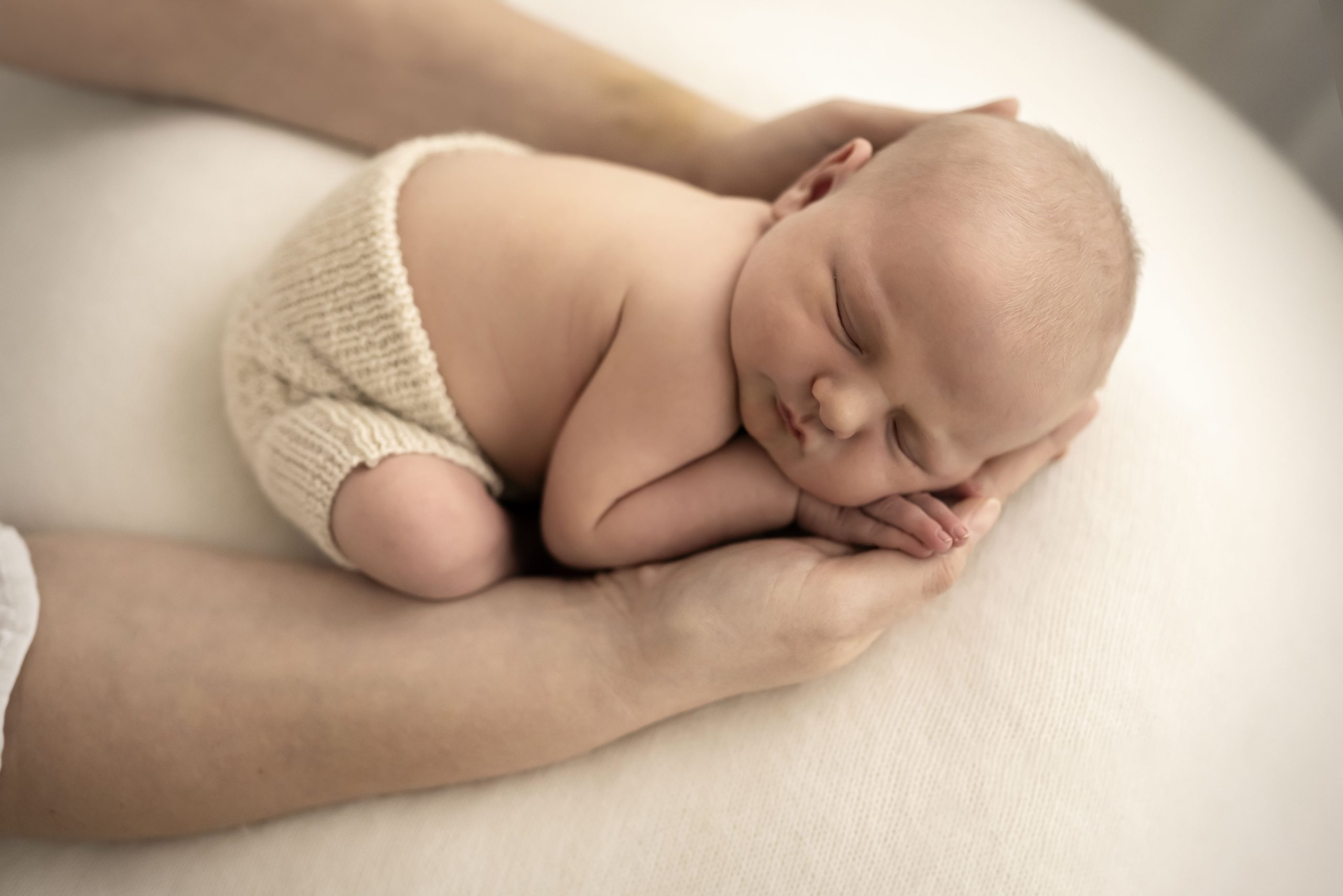  newborn baby cradeled in mums hands Timeless, perfect photograph taken by ISJ in Romford Essex